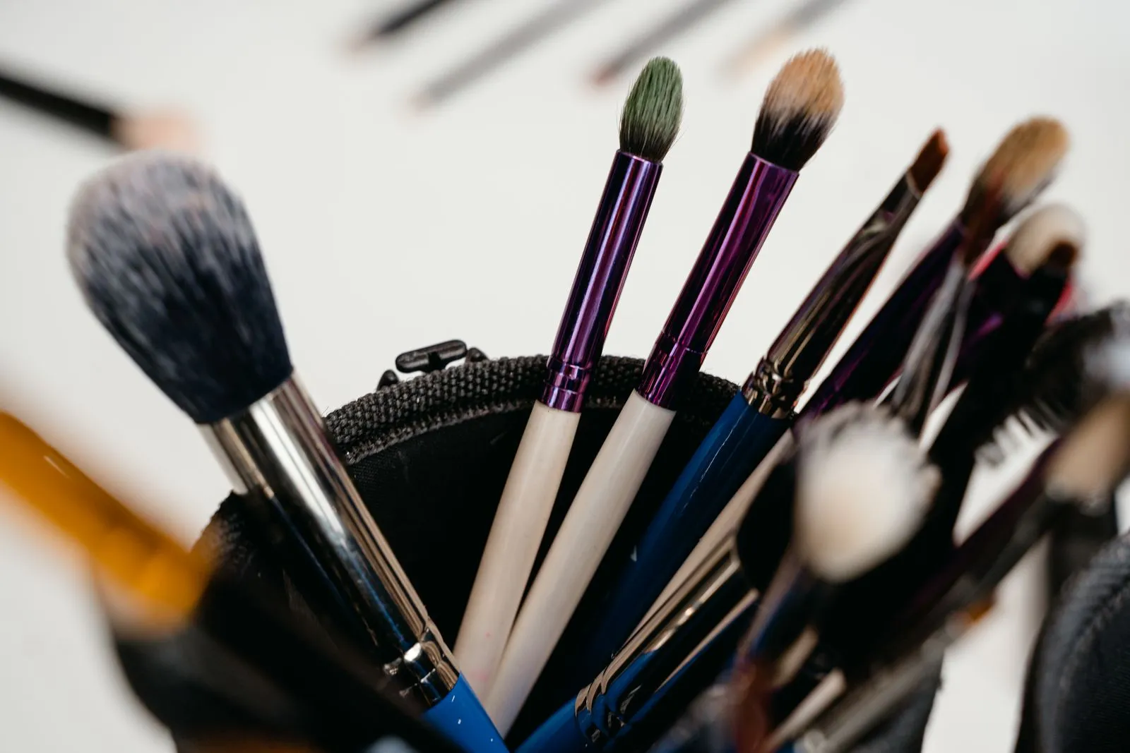 A close-up view of various makeup brushes arranged in a holder