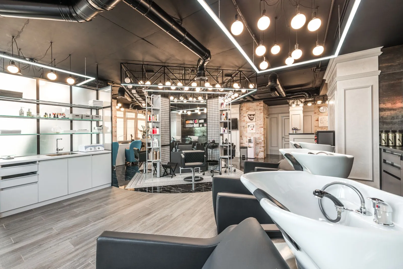 Backwash chairs with sinks placed in spacious modern beauty salon with stylish design and various cosmetology products w