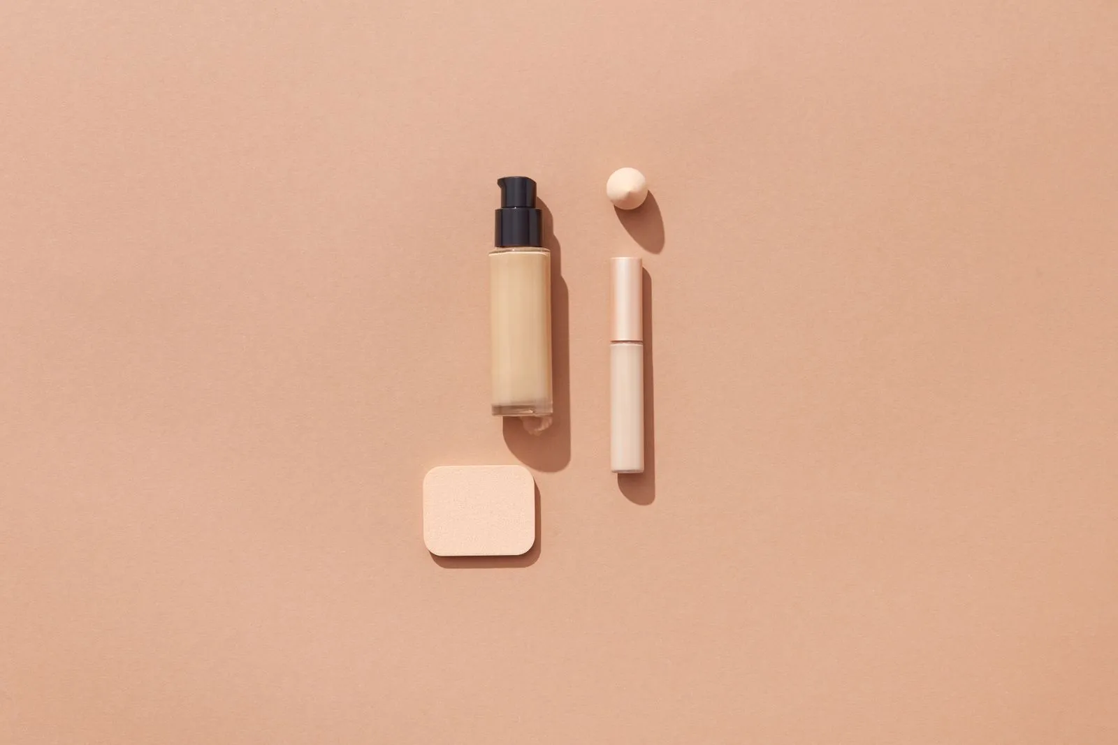 Flat lay of beauty products on a brown background with space for text