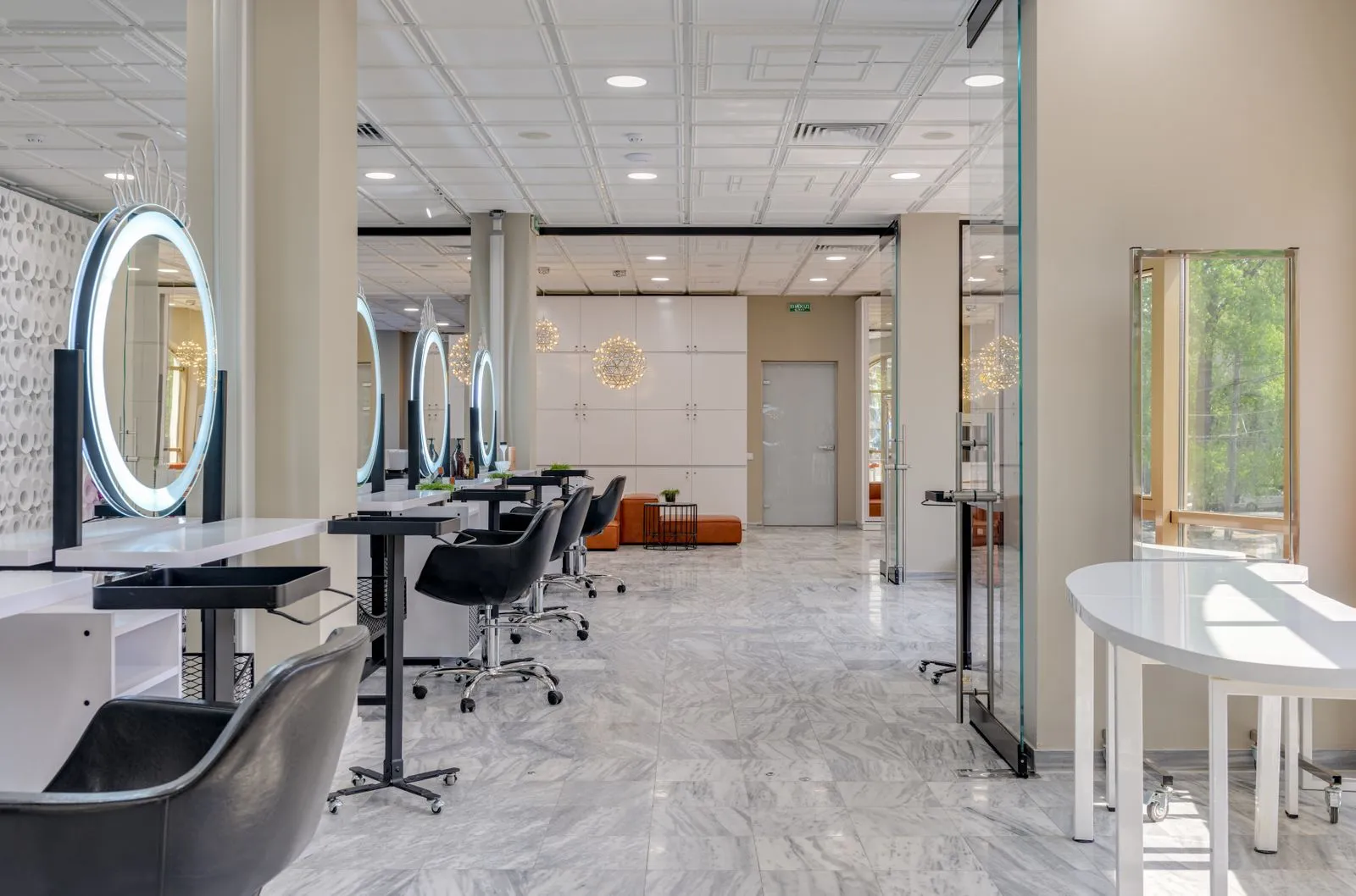Explore a spacious and contemporary beauty salon interior featuring sleek design, mirrors, and luxurious seating.