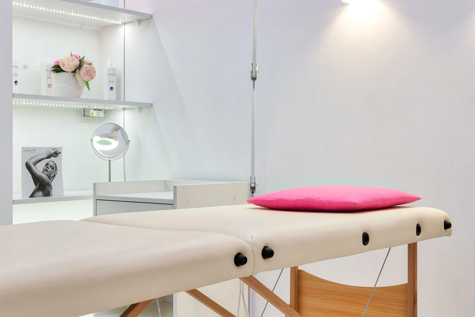 Interior of modern beauty office with couch for skincare procedures under glowing light