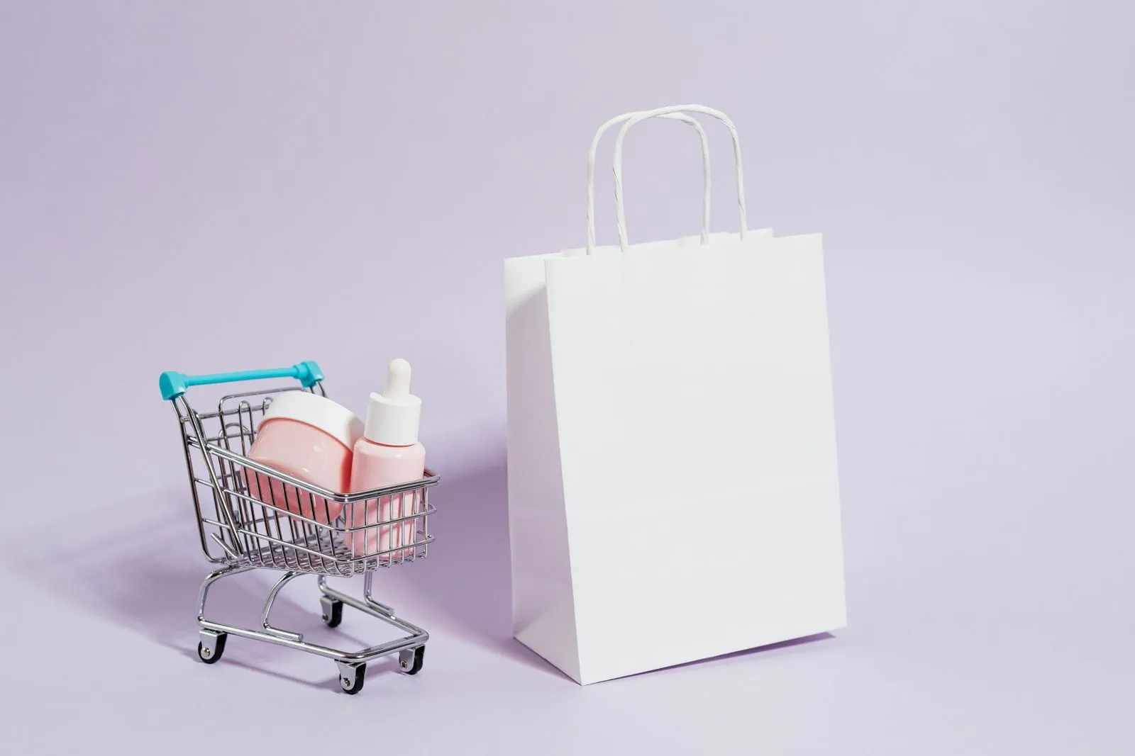A minimalist image featuring a shopping cart with cosmetics and a white paper bag