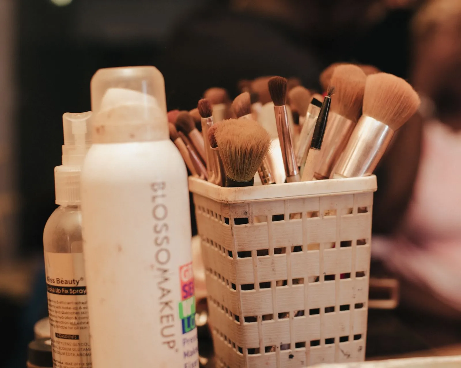 A collection of makeup brushes and beauty products neatly organized in a holder.