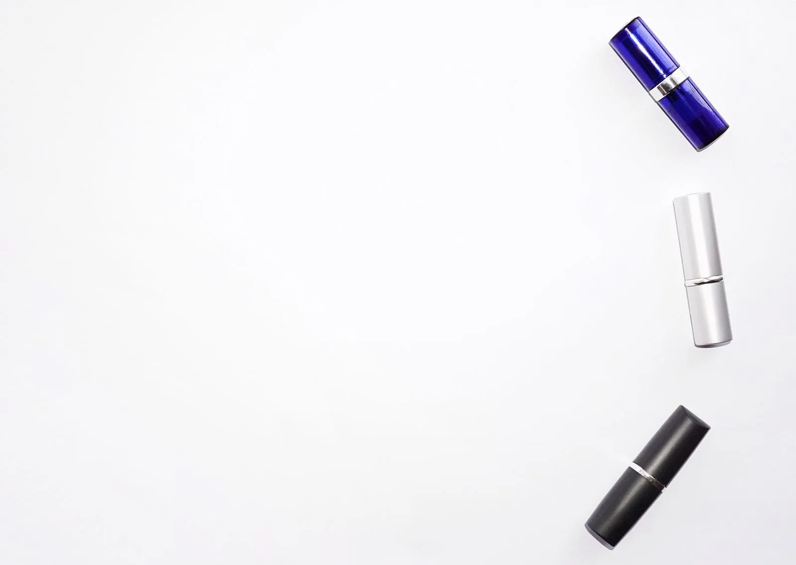 Three assorted lipstick tubes on a white background