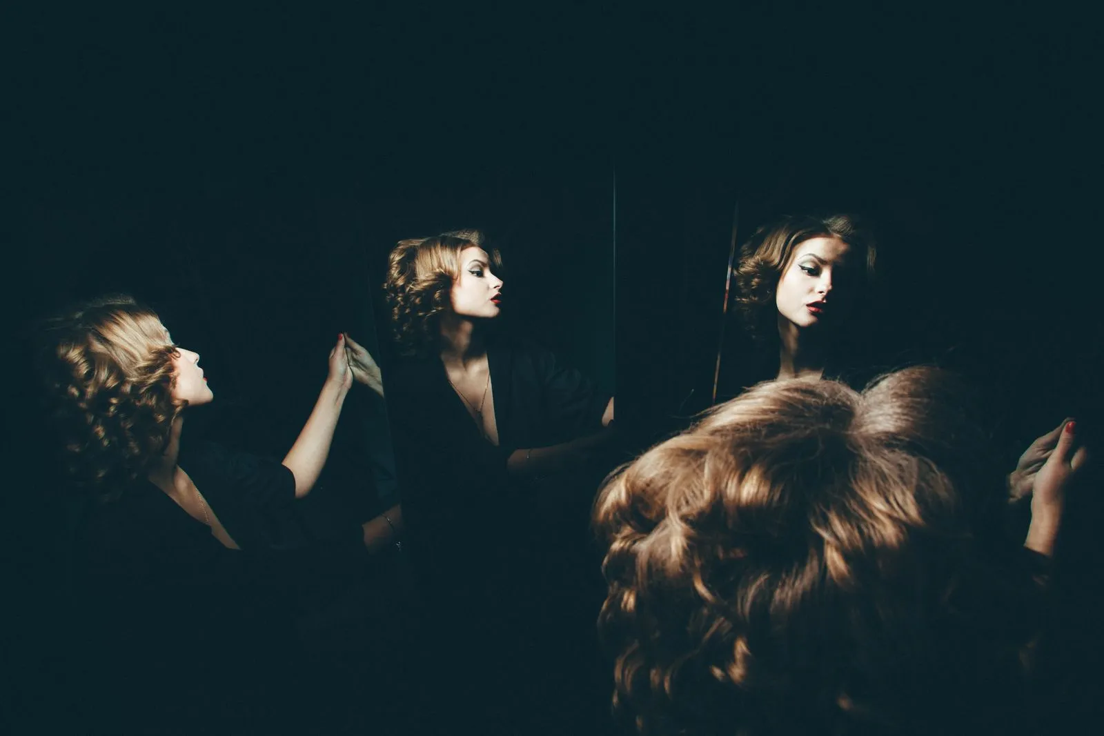 Artistic portrait of a woman reflected in mirrors