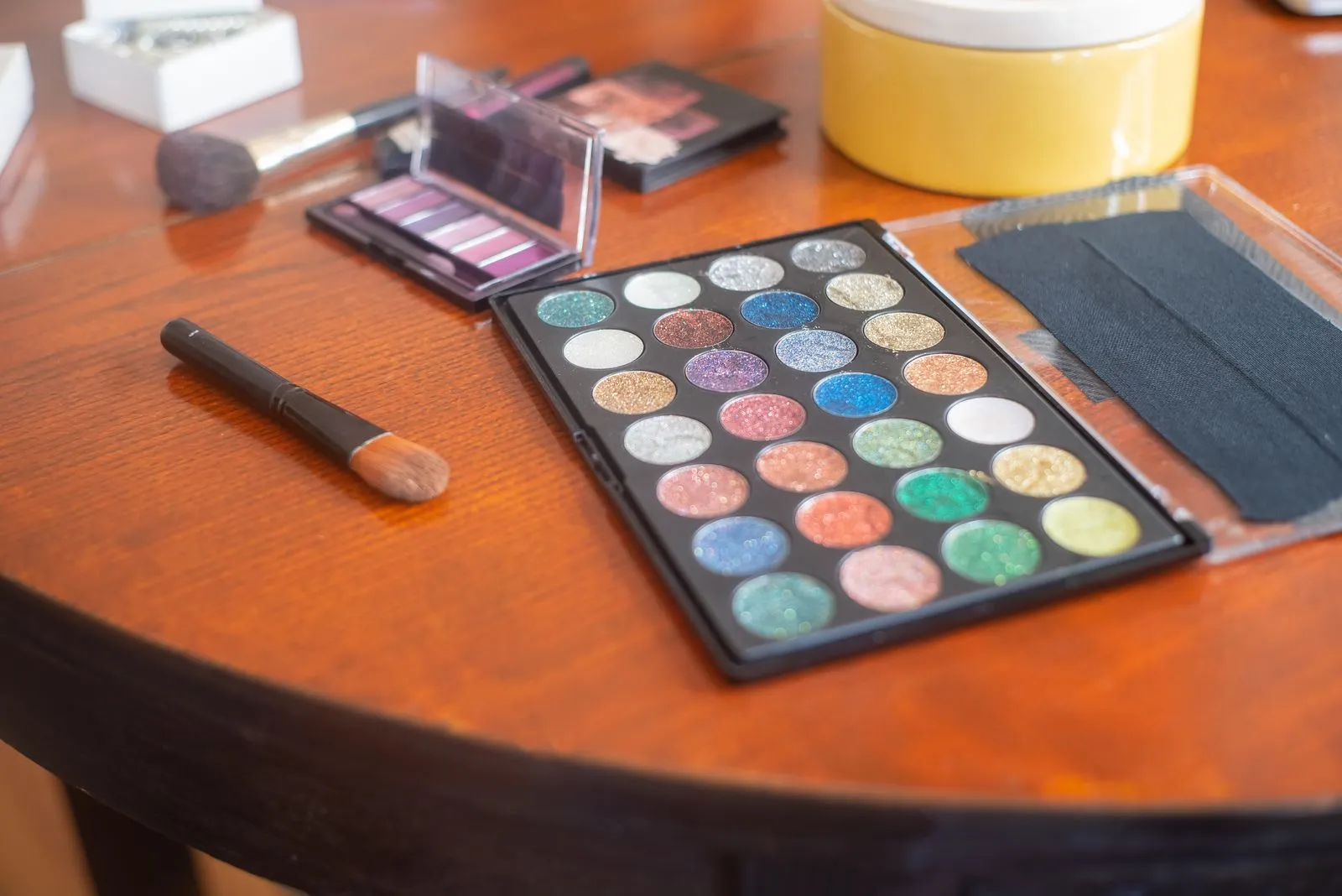Vivid eyeshadow palette with vibrant colors on a wooden table