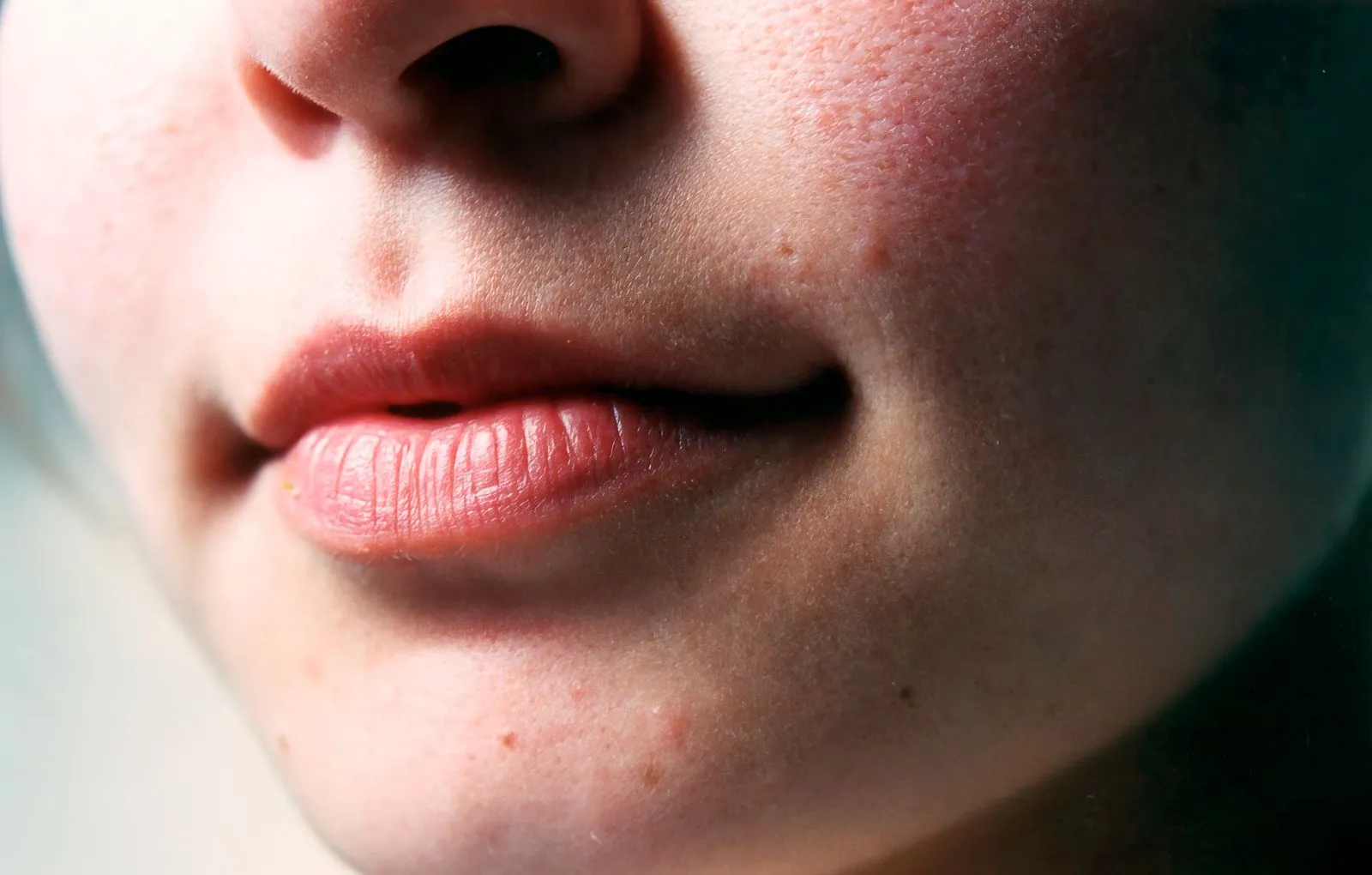 Close-up image highlighting a woman's lips and natural skin texture