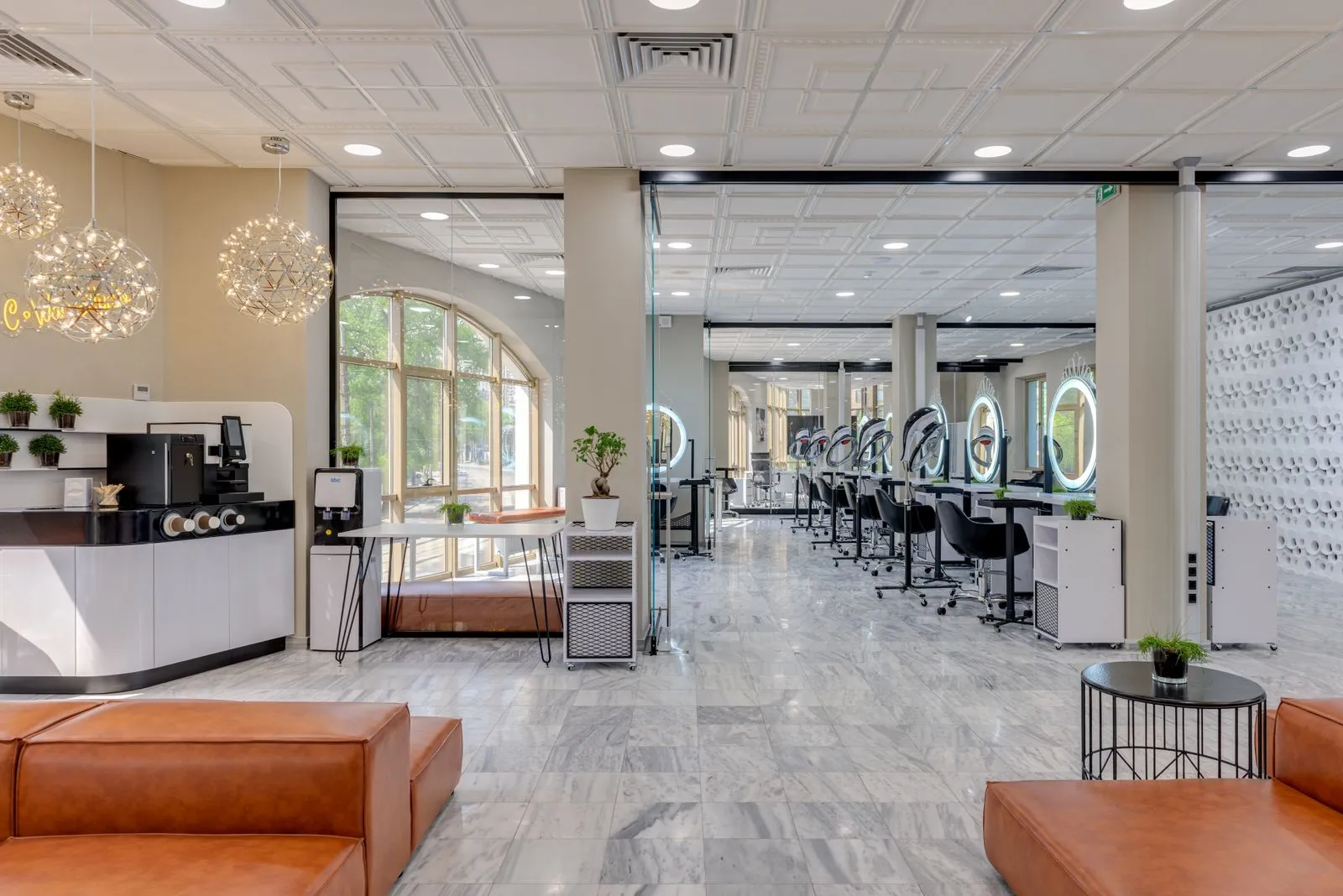 Spacious and modern beauty salon interior with stylish decor and lighting.
