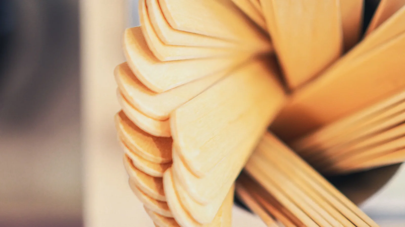 Flat wooden spatulas arranged in a small container.