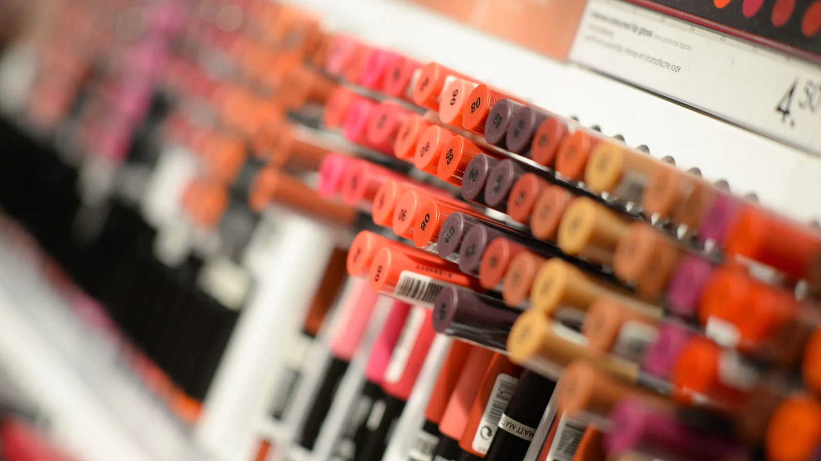 Rows of open lipstick shades in a shop display.