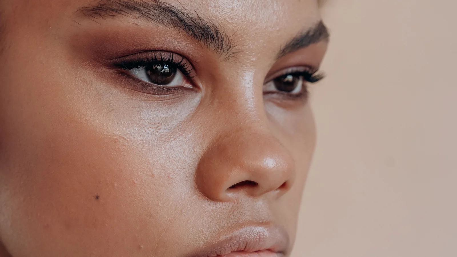 Portrait of a woman with natural facial texture and softly defined make-up.